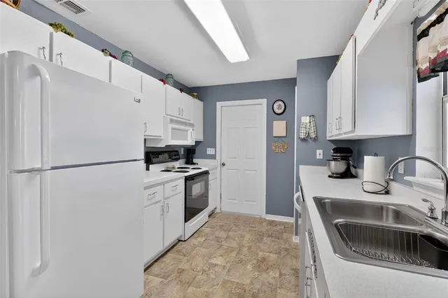 a kitchen with a refrigerator sink and stove