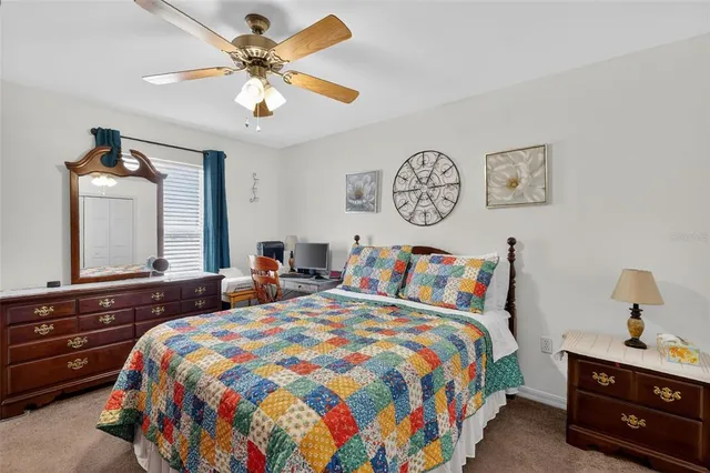 a bedroom with bed and a chandelier