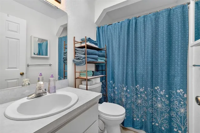 a bathroom with a toilet a sink and a mirror