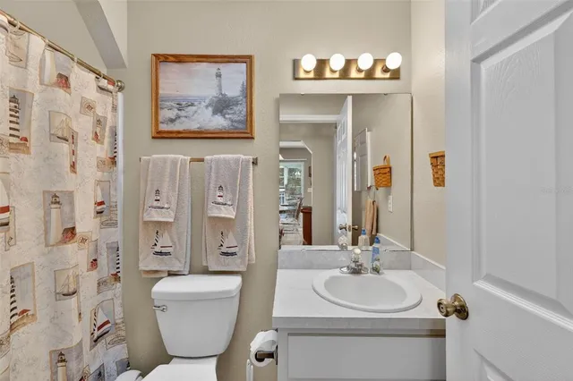 a bathroom with a toilet a sink and a mirror