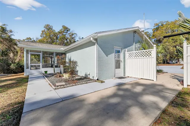 a view of a house with a patio and a yard