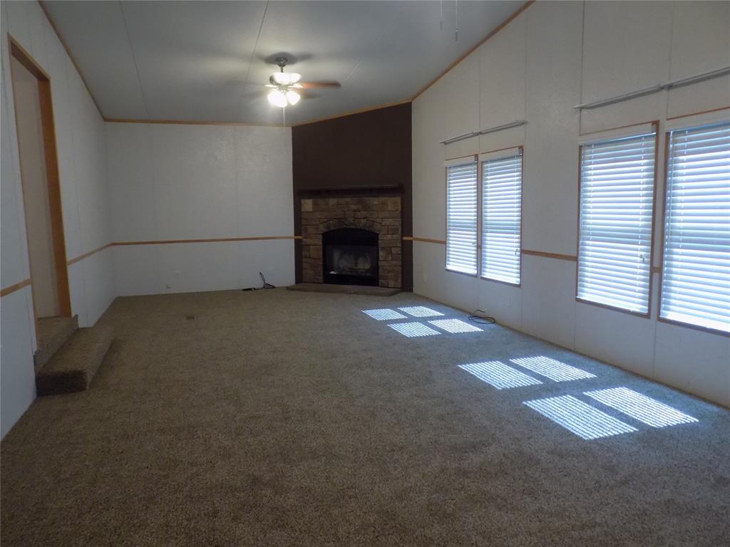 12792 Highway 199 Poolville, TX 76487 - Photo 10 of 24 Large second living room, loaded with windows and great fireplace