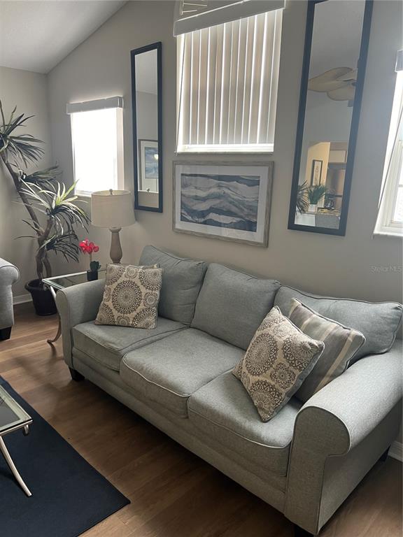 8713 Rockingham Terrace, Unit D Kissimmee, FL 34747 - Photo 5 of 14 a living room with furniture and a window