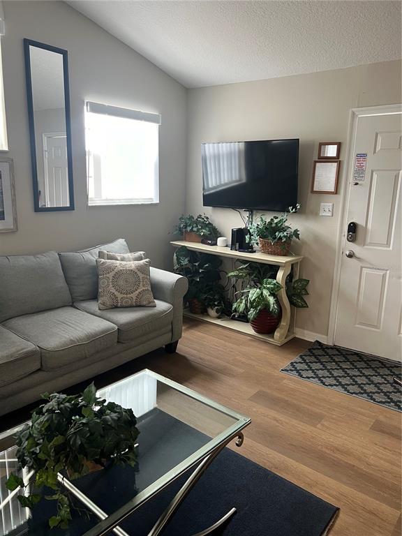 8713 Rockingham Terrace, Unit D Kissimmee, FL 34747 - Photo 6 of 14 a living room with furniture and a flat screen tv