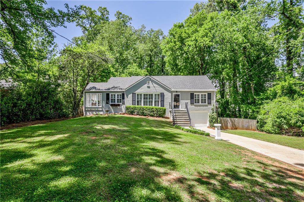 1362 Briarcliff Road Northeast Atlanta, GA 30306 - Photo 1 of 1 a front view of a house with a garden