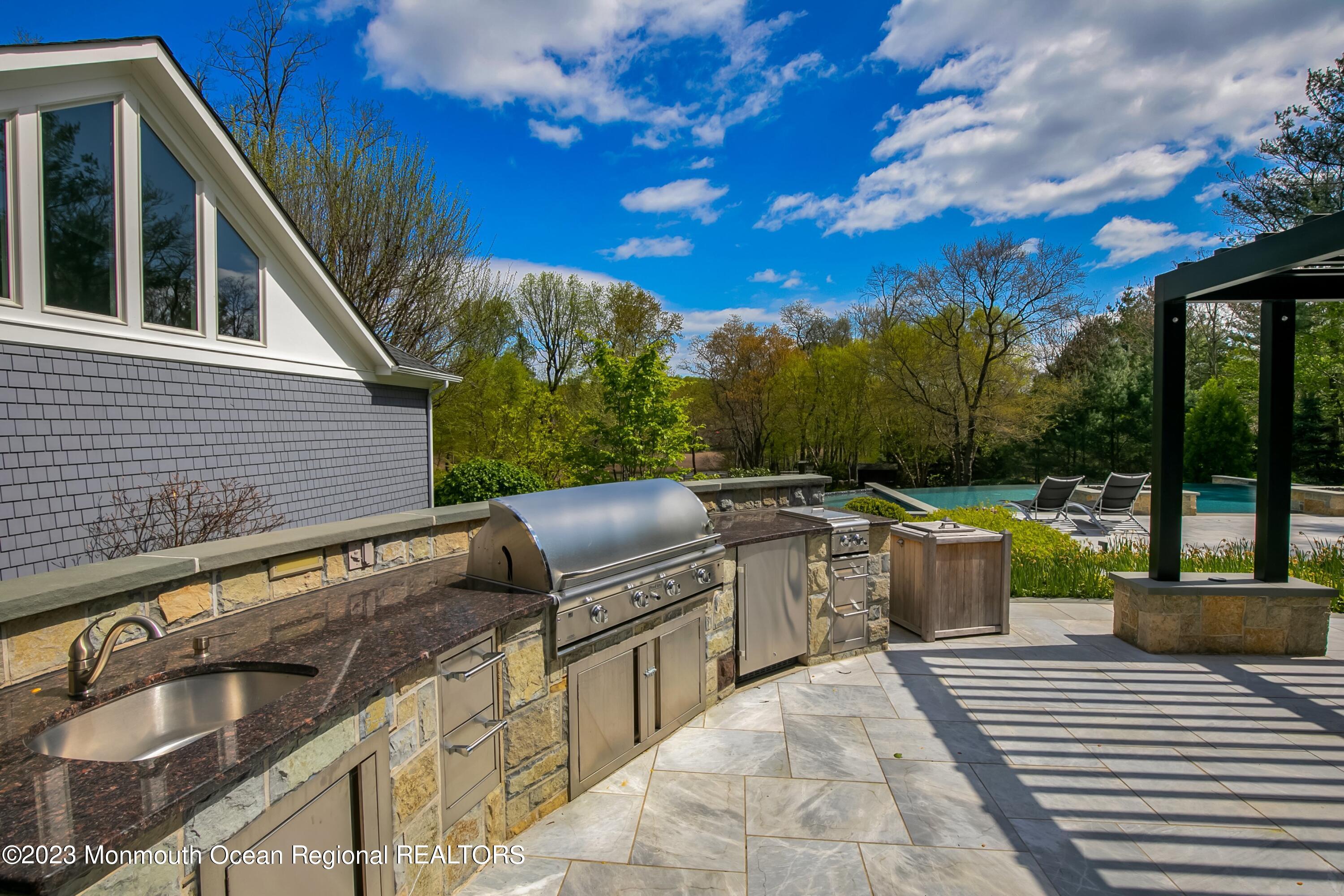17 Club Way Red Bank, NJ 07701 - Photo 61 of 72 a view of a patio with couches table and chairs and potted plants