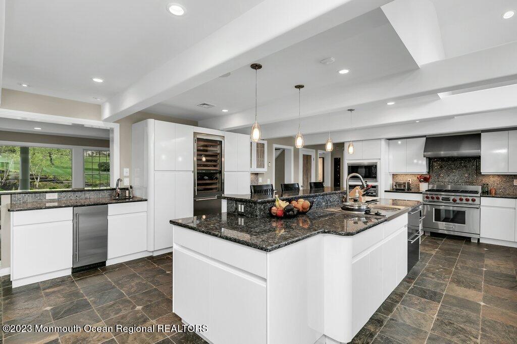 17 Club Way Red Bank, NJ 07701 - Photo 7 of 72 a kitchen with stainless steel appliances granite countertop a stove top oven a sink a counter space and cabinets