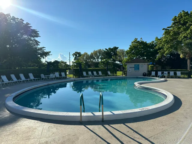 a view of a swimming pool with a yard