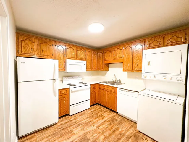 a kitchen with a stove a sink and a refrigerator