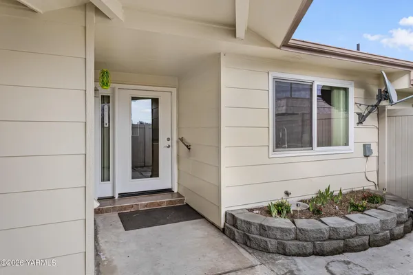 a view of a porch with a potted plant and a window