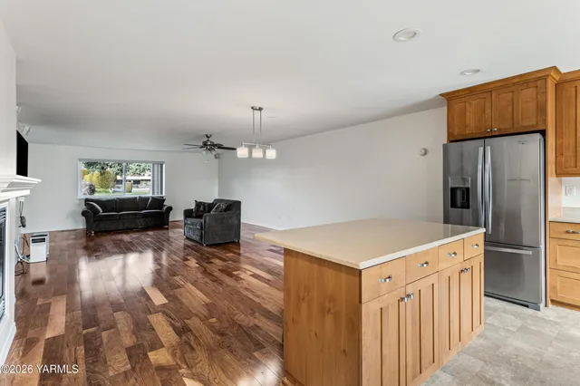 a kitchen that has a lot of cabinets and wooden floor