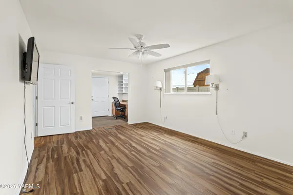 wooden floor in an empty room with a window
