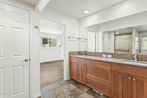 a bathroom with a granite countertop sink mirror and double