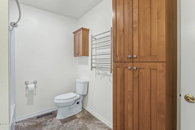 a white toilet sitting next to a small sink