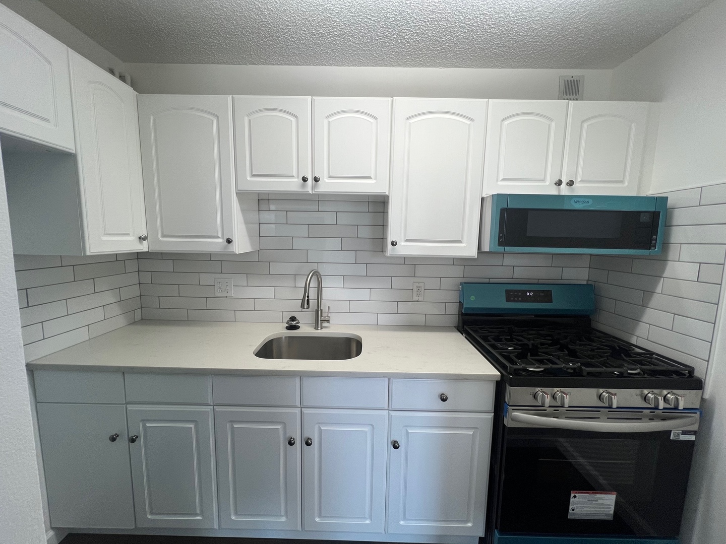1750 North Marywood Avenue, Unit 315 Aurora, IL 60505 - Photo 5 of 20 a kitchen with white cabinets and appliances