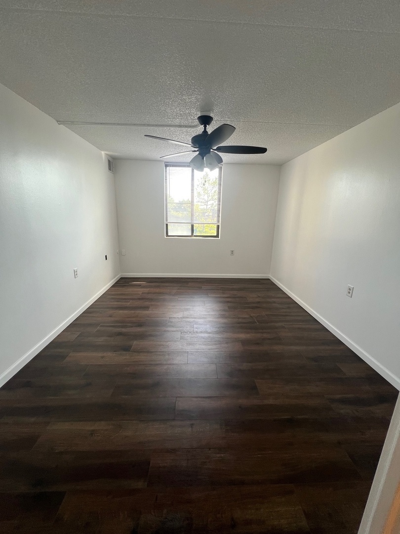 1750 North Marywood Avenue, Unit 315 Aurora, IL 60505 - Photo 9 of 20 an empty room with wooden floor and windows