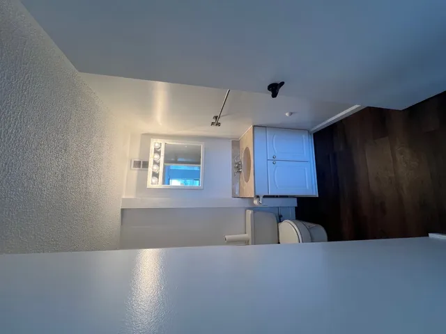 a kitchen with granite countertop white cabinets and black appliances