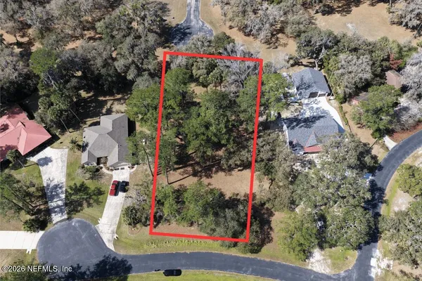an aerial view of residential houses and car parked on street