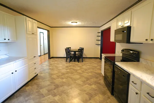 a kitchen with stainless steel appliances granite countertop a sink and cabinets