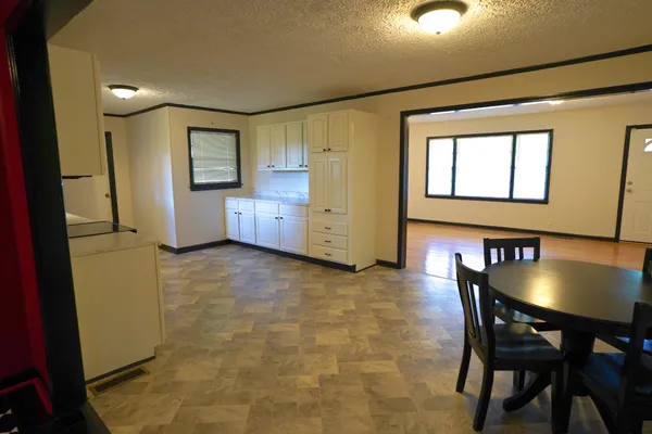 a view of a dining room with furniture and a chandelier