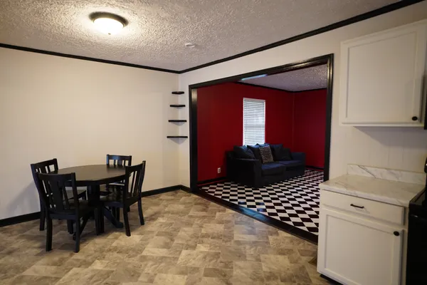 a view of a dining room with furniture and a window