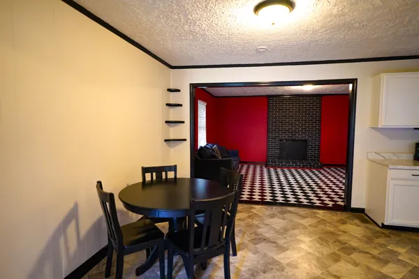 a view of a dining room with furniture and chandelier