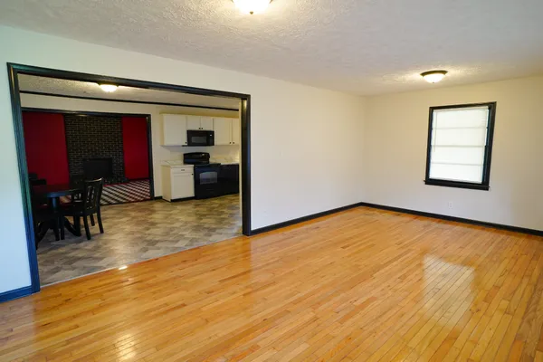 an empty room with wooden floor and furniture