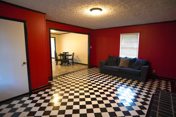 a living room with a black and white checkered floor