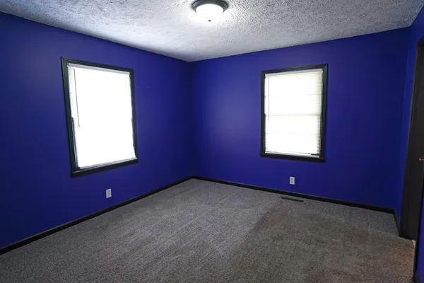a view of an empty room with windows