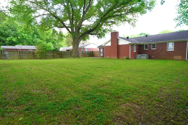 a view of a big yard with a house