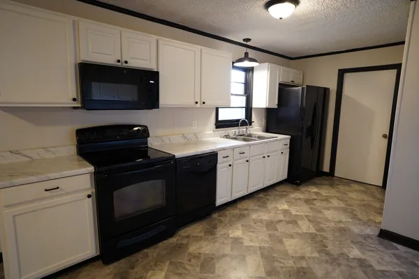 a kitchen with a sink stove and refrigerator