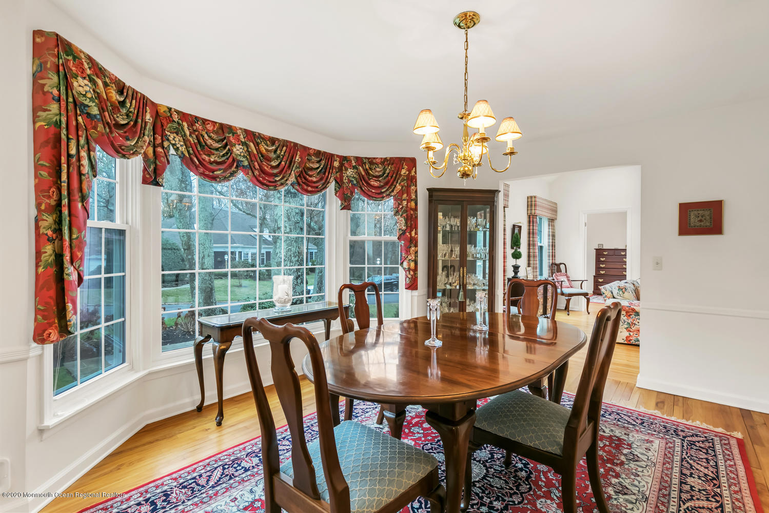 1 Berkeley Square Brielle, NJ 08730 - Photo 14 of 28 a dining room with furniture a chandelier and wooden floor
