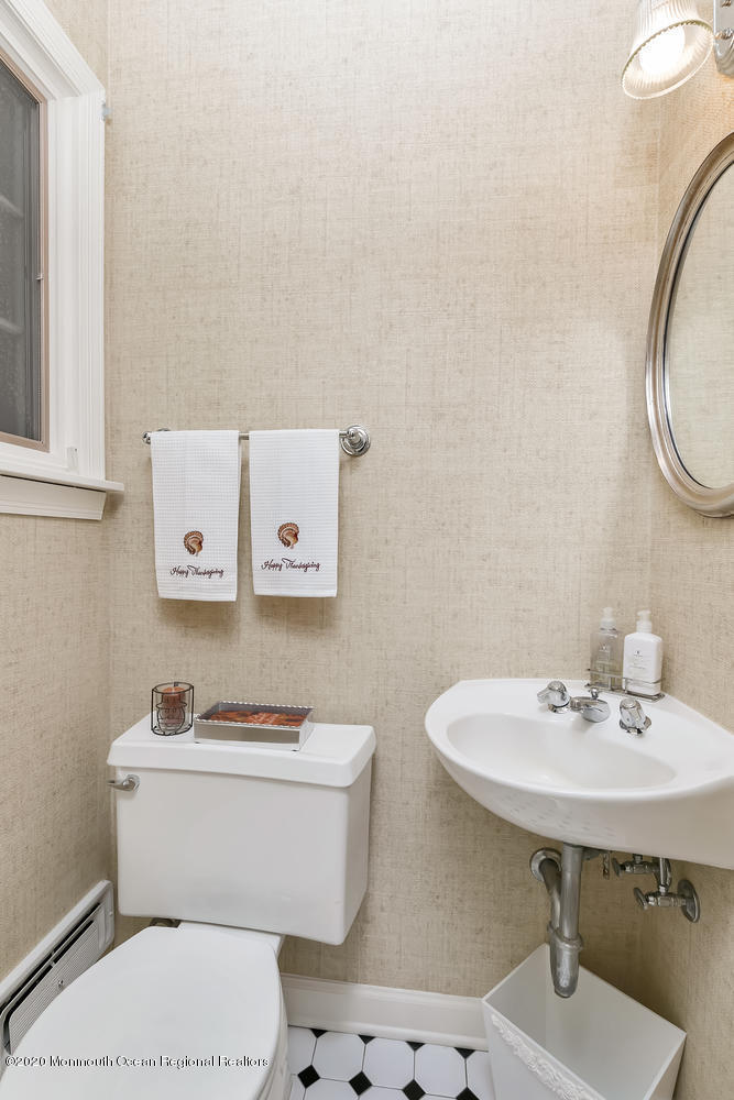 1 Berkeley Square Brielle, NJ 08730 - Photo 18 of 28 a bathroom with a sink a mirror and a toilet