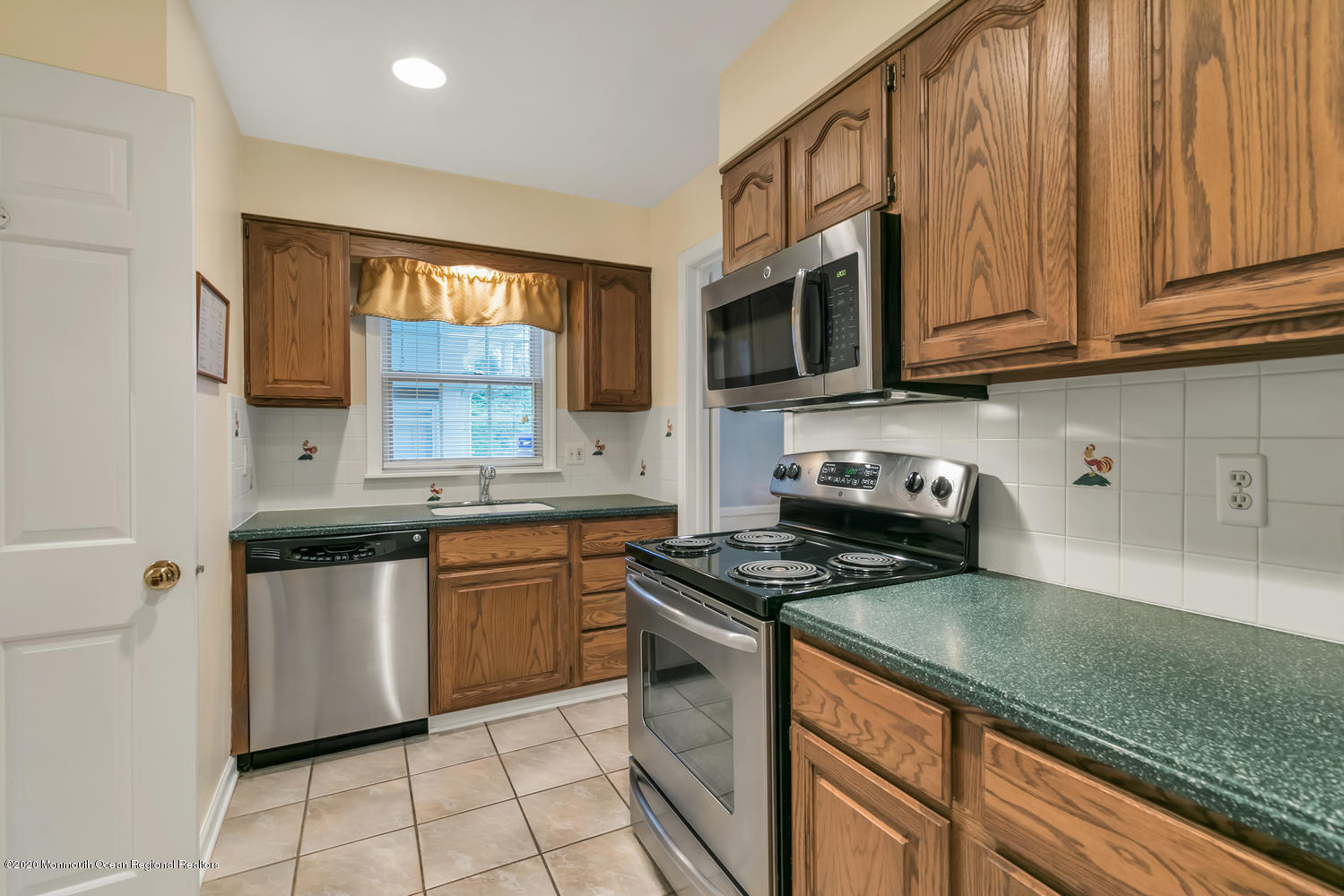 1 Berkeley Square Brielle, NJ 08730 - Photo 7 of 28 a kitchen with stainless steel appliances granite countertop a stove a sink and a microwave