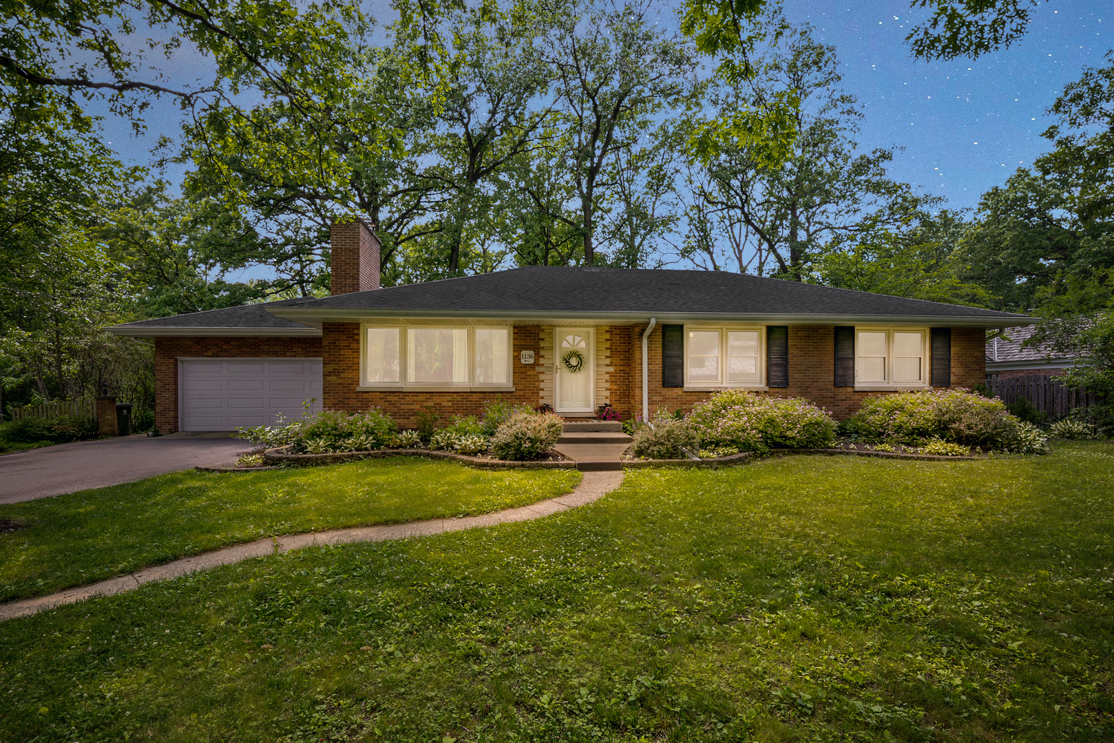 a front view of a house with garden and porch