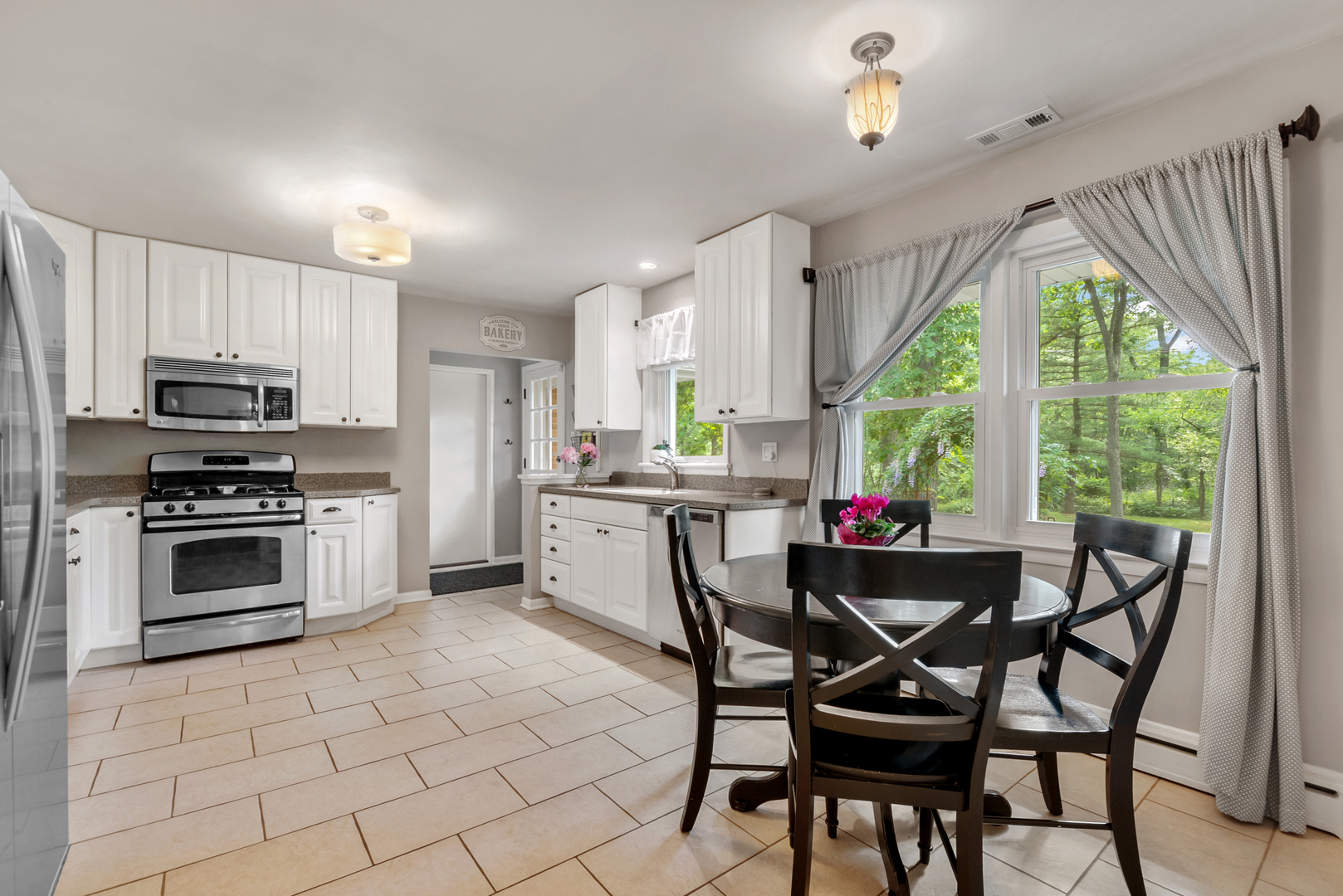 1136 Waveland Road Lake Forest, IL 60045 - Photo 7 of 18 a kitchen with stainless steel appliances a stove a sink refrigerator and a chair