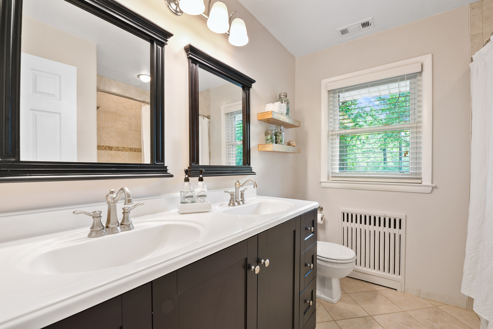 1136 Waveland Road Lake Forest, IL 60045 - Photo 10 of 18 a bathroom with a double vanity sink toilet and a mirror