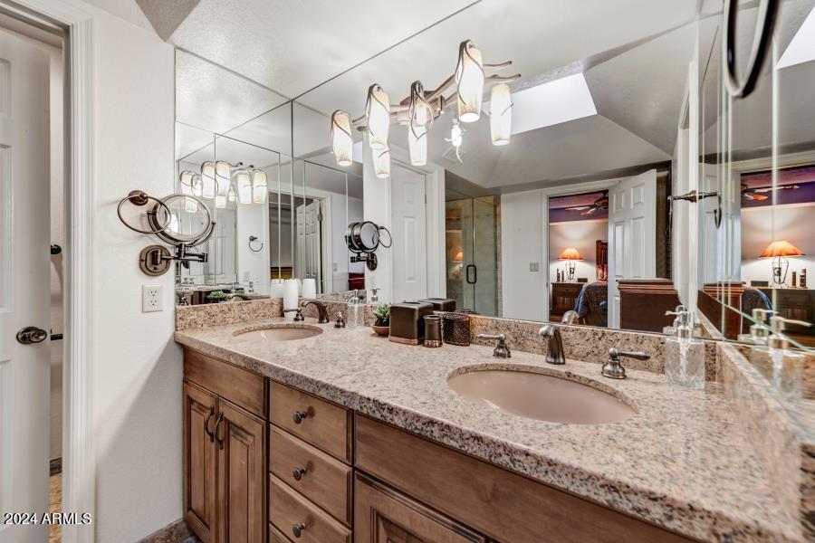 19049 East Poco Rio Drive Rio Verde, AZ 85263 - Photo 19 of 37 a bathroom with a granite countertop sink and a mirror