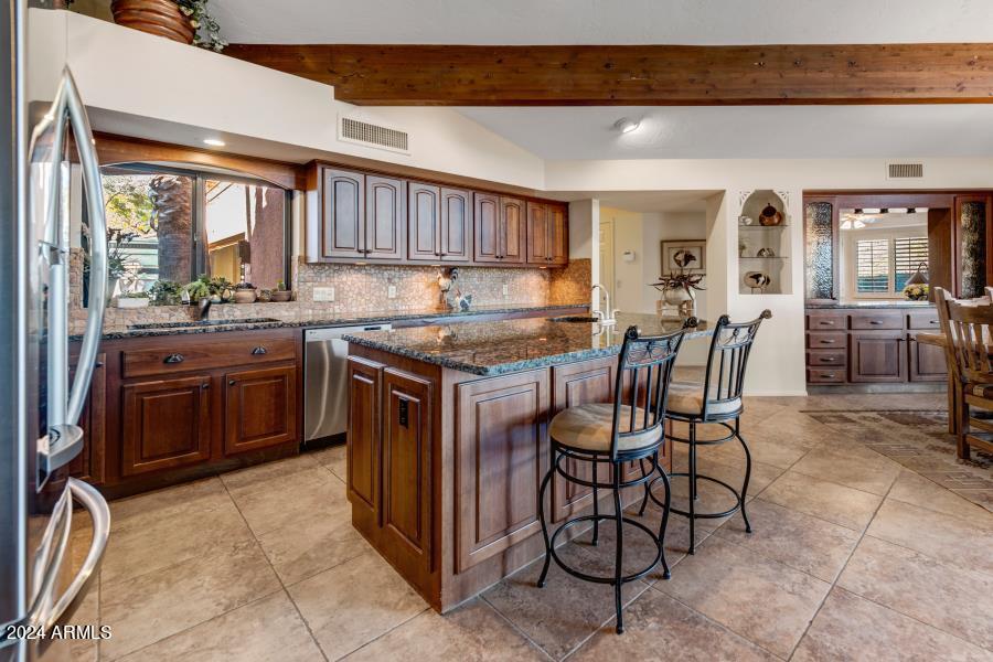 19049 East Poco Rio Drive Rio Verde, AZ 85263 - Photo 29 of 37 a kitchen with a stove a sink and a refrigerator