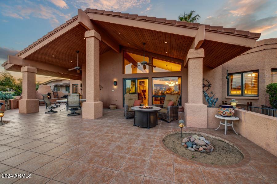 19049 East Poco Rio Drive Rio Verde, AZ 85263 - Photo 6 of 37 a view of a patio with dining table and chairs