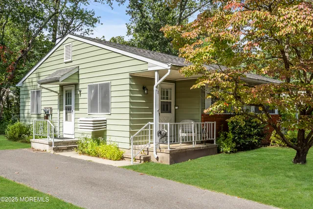 a front view of a house with a garden and yard