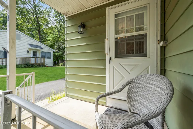 a view of backyard with deck and outdoor seating