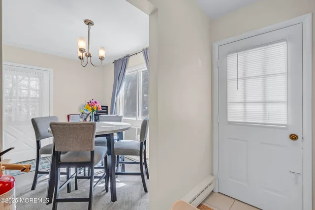 a view of a dining room with furniture and a chandelier