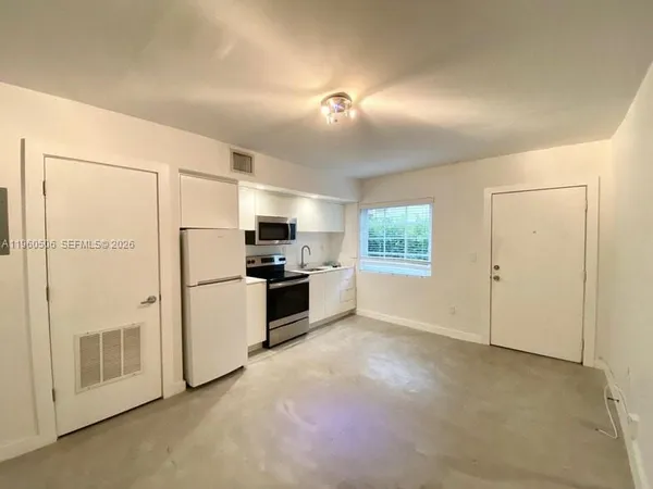 a view of a kitchen with a sink refrigerator and a stove