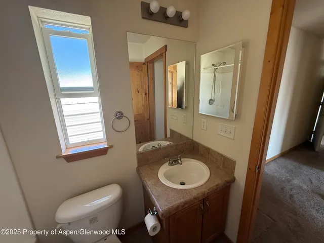 a bathroom with a sink toilet and mirror