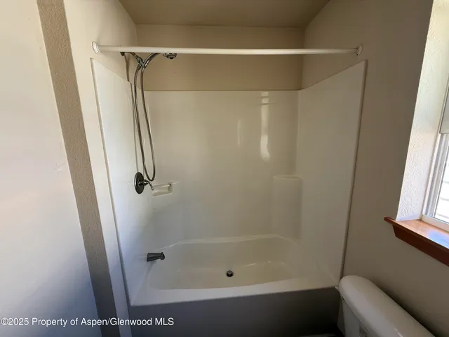 a bathroom with a shower and a bath tub