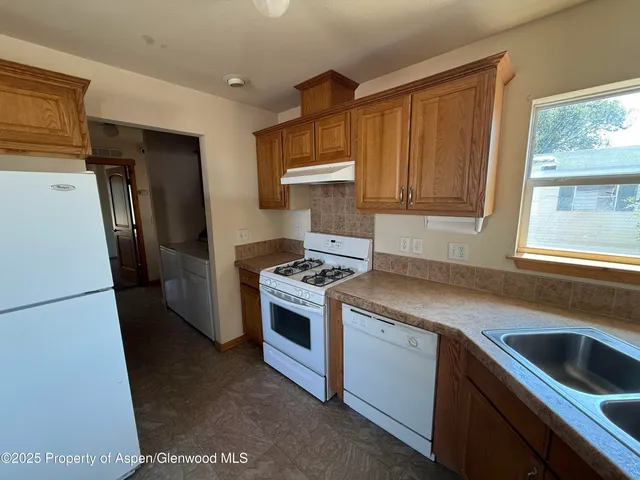 a kitchen with a stove sink and refrigerator