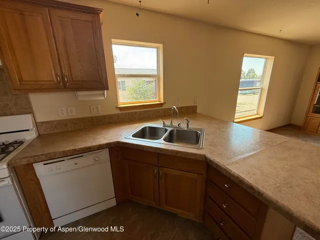 a kitchen with a sink cabinets and window