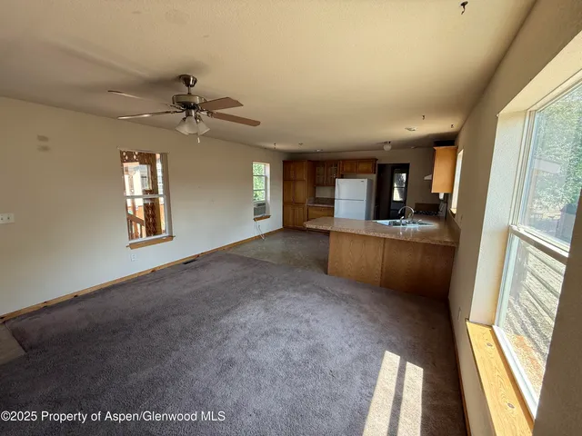 a view of a kitchen with a sink cabinet a fireplace and a window