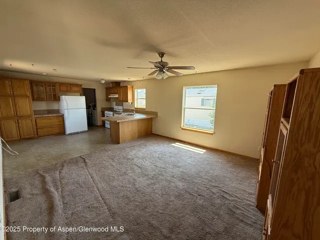 a view of a livingroom with furniture and a window